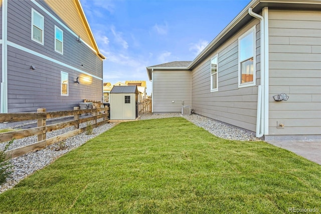 view of yard featuring a shed and central AC