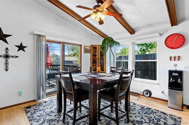 214 Poppy St, Golden, CO 80401 - dining area with a textured ceiling, healthy amount of natural light, ceiling fan, light wood-style flooring, and baseboards