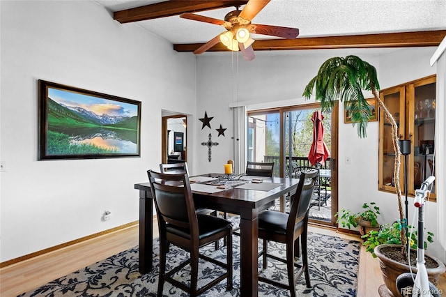 214 Poppy St, Golden, CO 80401 - dining area with beamed ceiling, a ceiling fan, baseboards, wood finished floors, and a textured ceiling