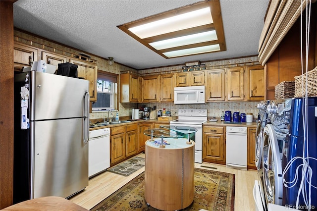 214 Poppy St, Golden, CO 80401 - kitchen with white appliances, light wood-type flooring, a kitchen island, light countertops, and a textured ceiling