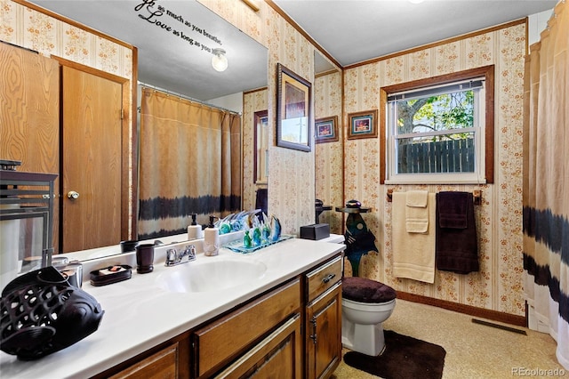214 Poppy St, Golden, CO 80401 - full bath with wallpapered walls, vanity, toilet, baseboards, and ornamental molding