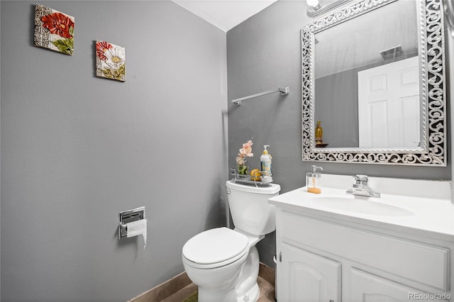 bathroom with toilet and vanity