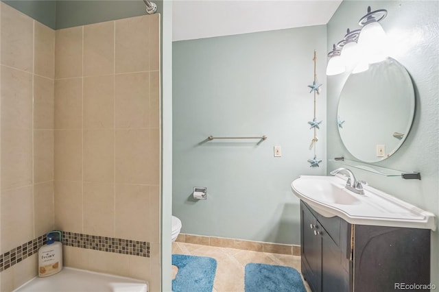 bathroom with vanity, a tub, toilet, and tile patterned flooring