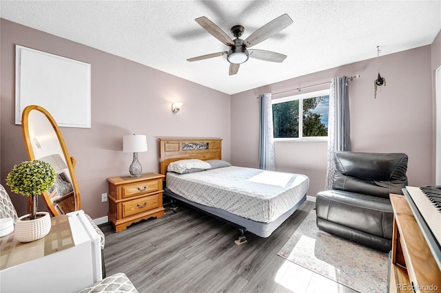 bedroom featuring a textured ceiling, hardwood / wood-style flooring, and ceiling fan