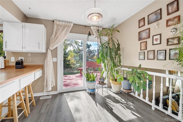 interior space featuring a textured ceiling and hardwood / wood-style floors