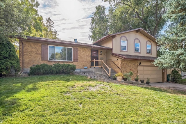 tri-level home featuring a front yard and a garage