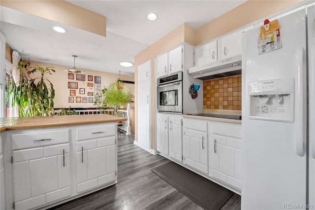 kitchen with oven, white refrigerator with ice dispenser, white cabinetry, a textured ceiling, and dark hardwood / wood-style flooring