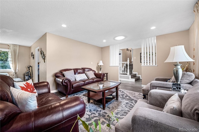 living room featuring a textured ceiling and hardwood / wood-style flooring