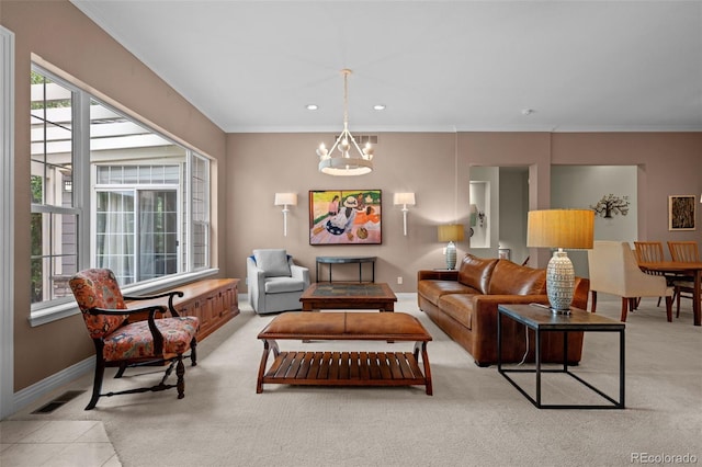 carpeted living room featuring crown molding and a chandelier