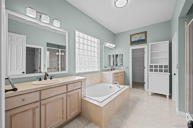 bathroom featuring separate shower and tub, tile patterned flooring, and dual bowl vanity