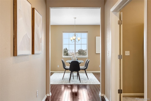 dining area featuring an inviting chandelier and dark hardwood / wood-style floors