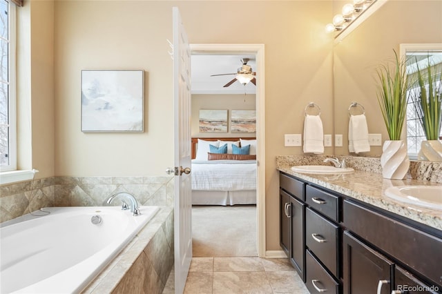 bathroom with tile patterned floors, vanity, and tiled tub