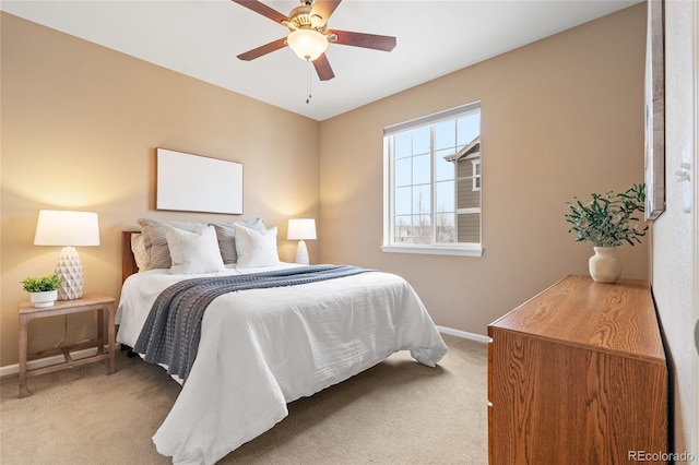 bedroom featuring ceiling fan and light colored carpet