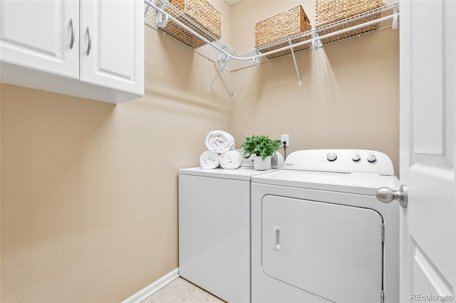 laundry area featuring cabinets and washing machine and dryer