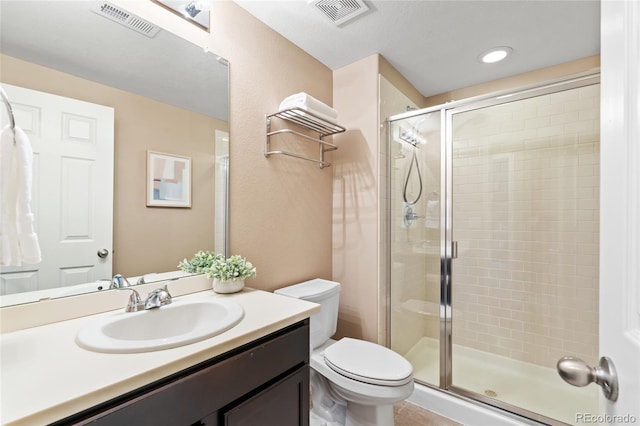 bathroom with vanity, an enclosed shower, and toilet