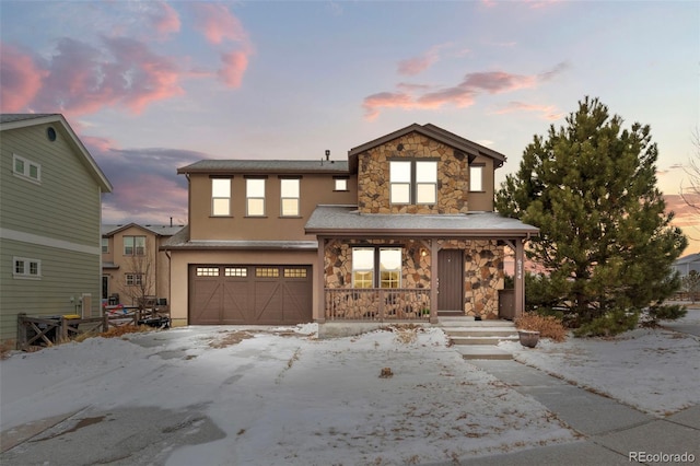 front facade featuring covered porch and a garage