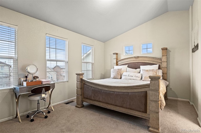 carpeted bedroom featuring multiple windows and lofted ceiling