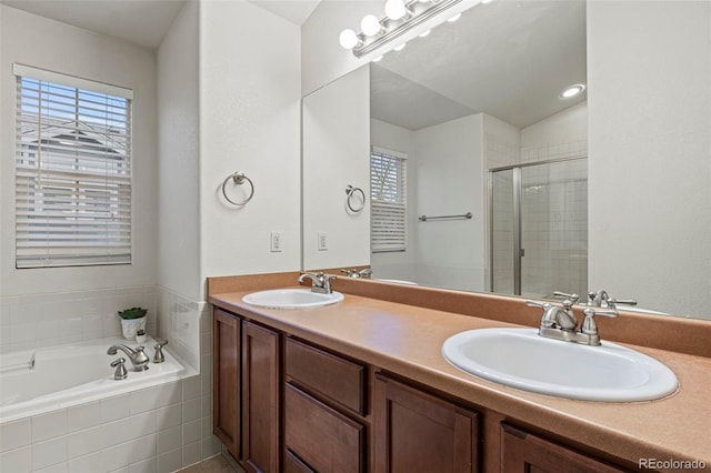 bathroom with vanity and independent shower and bath