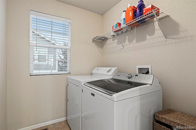 washroom with washing machine and dryer and light tile patterned floors