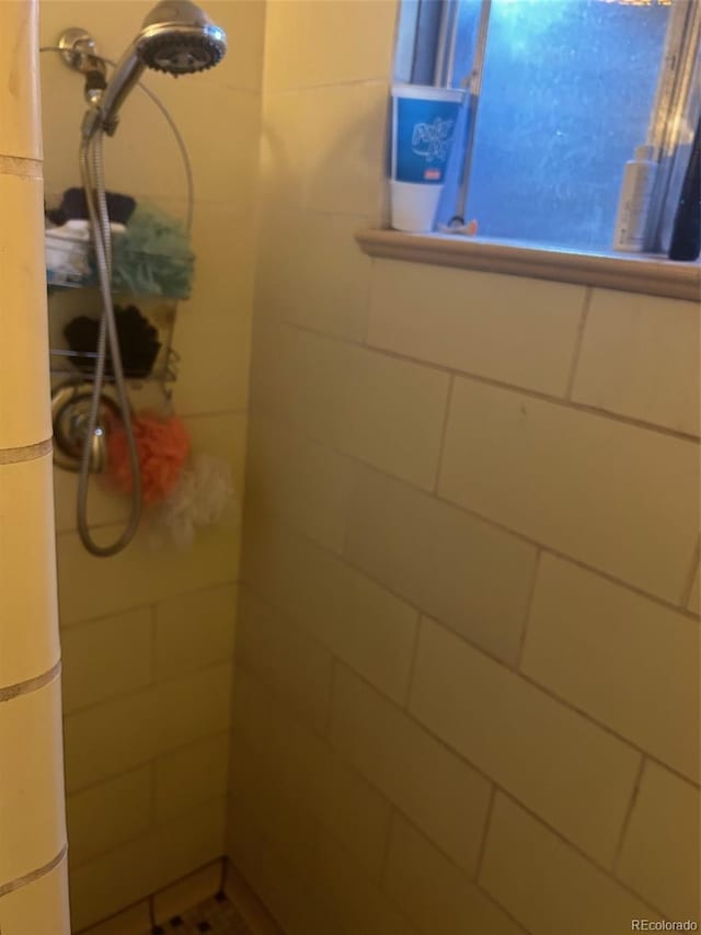 bathroom with tiled shower