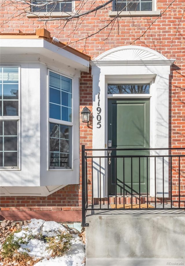 property entrance with brick siding