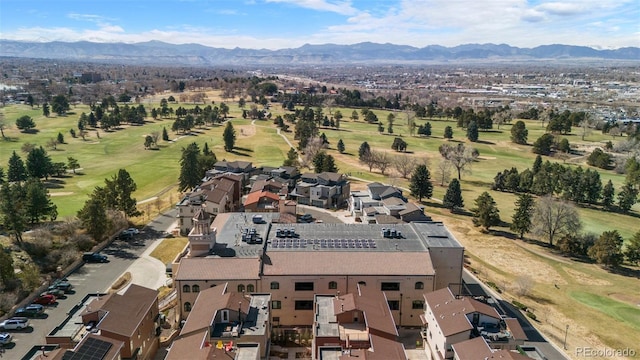 drone / aerial view with golf course view, a residential view, and a mountain view