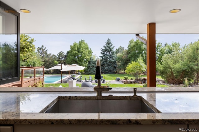 exterior space featuring sink and a swimming pool