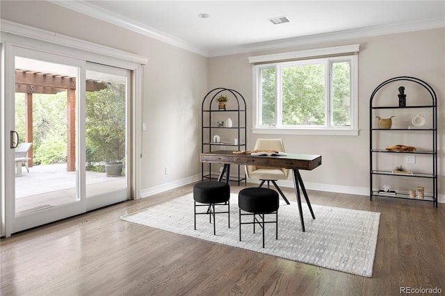 dining space featuring ornamental molding, plenty of natural light, and dark hardwood / wood-style flooring