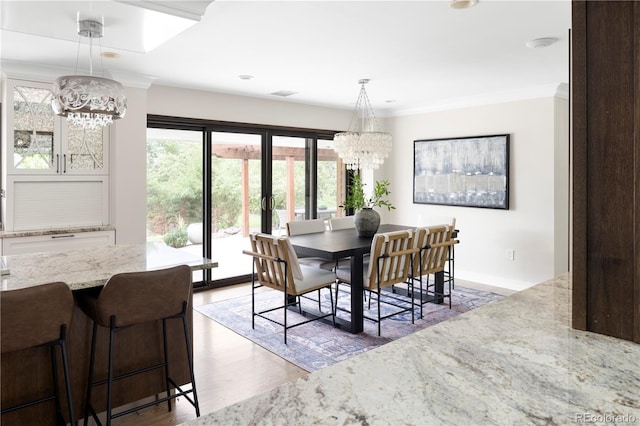 dining room featuring ornamental molding, dark hardwood / wood-style floors, and a chandelier