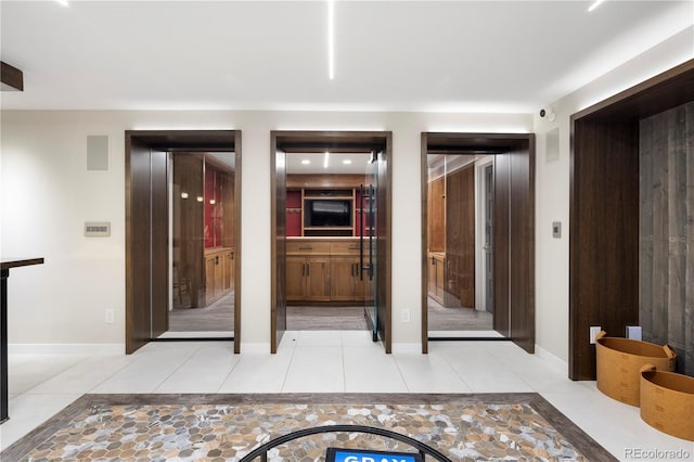 hall featuring light tile patterned flooring