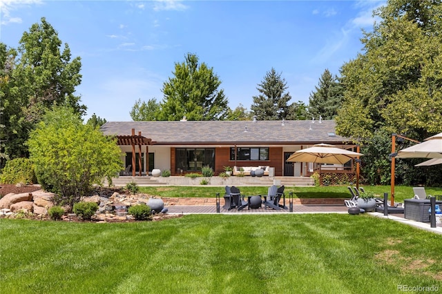 rear view of house featuring an outdoor living space, a patio area, and a lawn