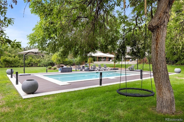 view of pool featuring a yard