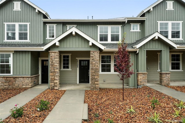 17125 W 91st Ln, Arvada, CO 80007 - craftsman-style house featuring board and batten siding, stone siding, a porch, and a shingled roof