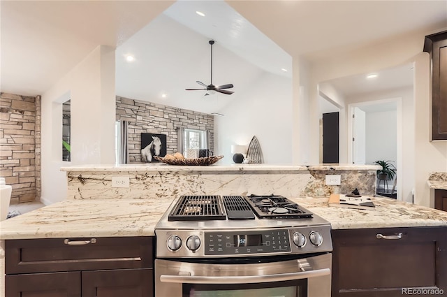 15280 Bannock St, Broomfield, CO 80023 - kitchen with stainless steel gas stove, dark brown cabinetry, a ceiling fan, light stone counters, and vaulted ceiling