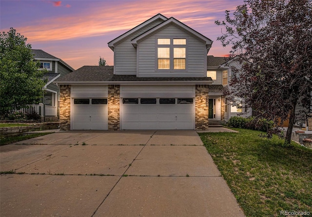 5755 S Zante Cir, Aurora, CO 80015 - traditional home featuring driveway, brick siding, a front yard, a shingled roof, and a garage