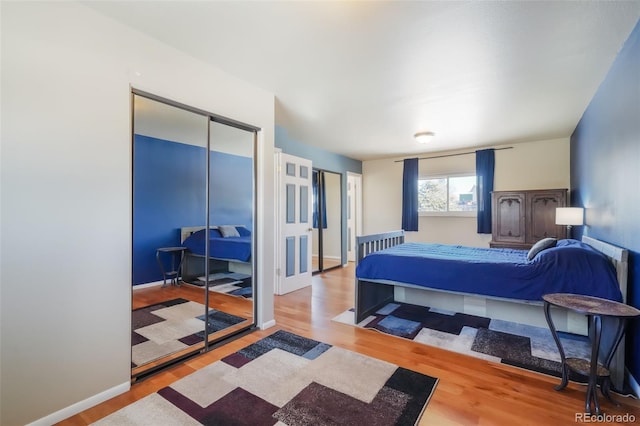 bedroom with hardwood / wood-style flooring and a closet