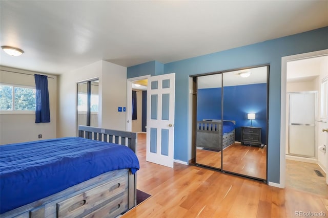 bedroom with hardwood / wood-style flooring and multiple closets