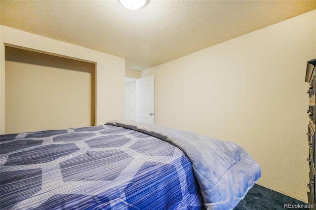 bedroom with carpet and a closet