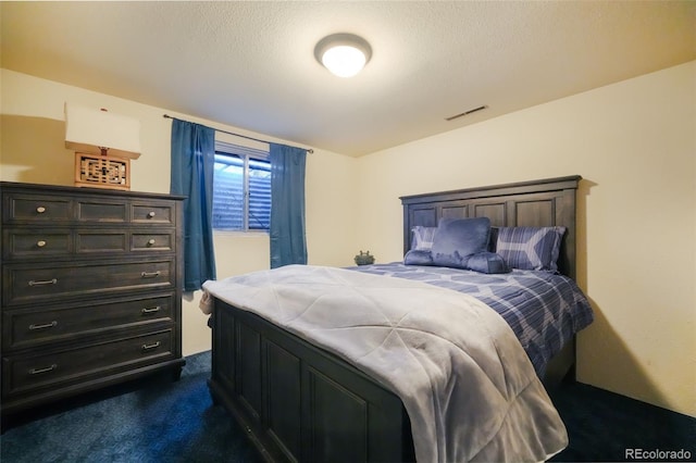 carpeted bedroom featuring a textured ceiling