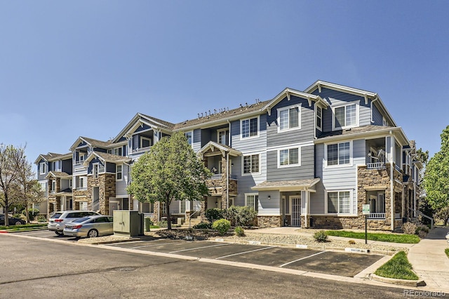 5255 Memphis St Unit 311, Denver, CO 80239 - multi unit property featuring uncovered parking, stone siding, and a residential view