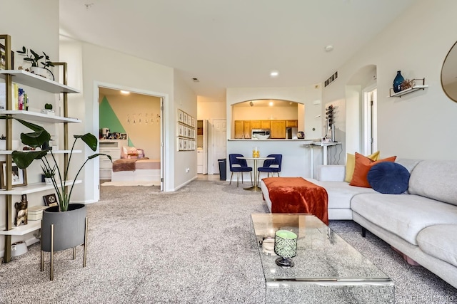 5255 Memphis St Unit 311, Denver, CO 80239 - living room featuring arched walkways and light carpet