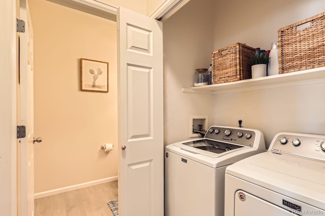 5255 Memphis St Unit 311, Denver, CO 80239 - washroom featuring washer and clothes dryer, light wood-style flooring, and baseboards