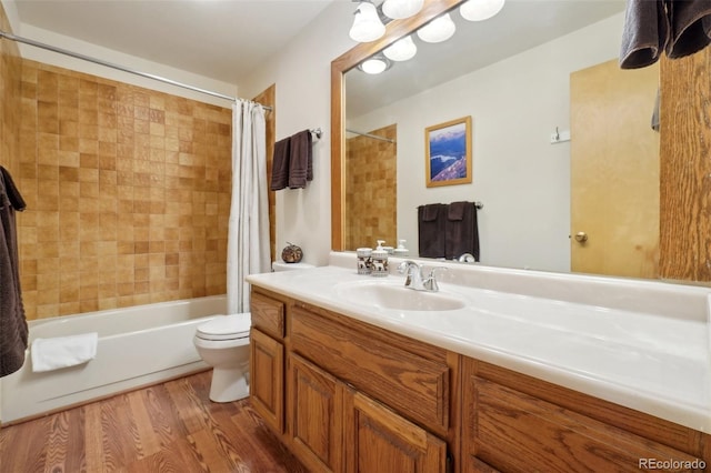 full bath featuring toilet, shower / bath combo with shower curtain, wood finished floors, and vanity