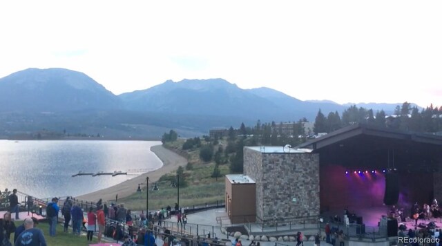 view of mountain backdrop featuring a nearby body of water