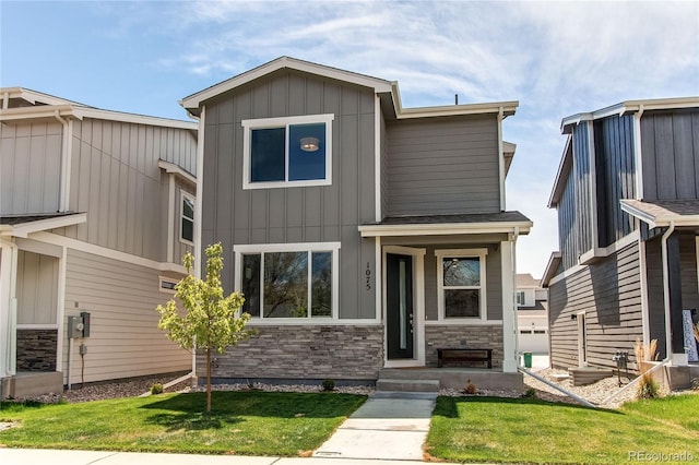 1075 Spartan Ave, Berthoud, CO 80513 - view of front of property featuring a front lawn, board and batten siding, and stone siding