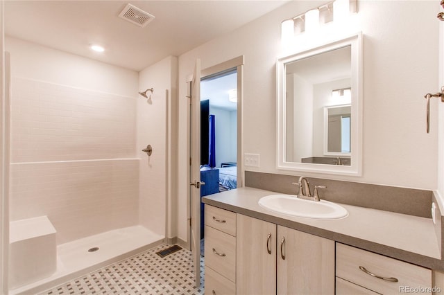 1075 Spartan Ave, Berthoud, CO 80513 - bathroom with vanity, tiled shower, and visible vents