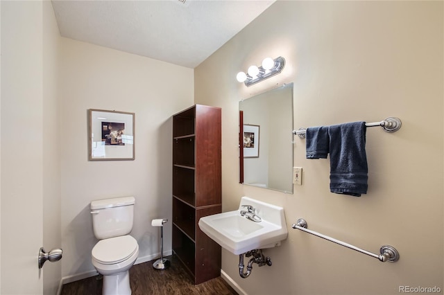 1350 Tolland Rd, Rollinsville, CO 80474 - half bath with a sink, baseboards, toilet, and wood finished floors