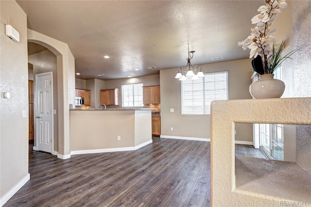 kitchen featuring a wealth of natural light, dark hardwood / wood-style floors, and a textured ceiling