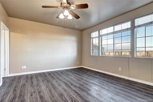 spare room with dark wood-type flooring and ceiling fan