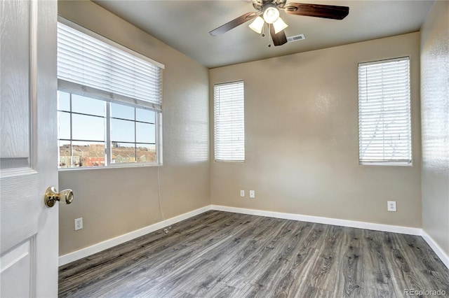 unfurnished room with ceiling fan and dark hardwood / wood-style flooring